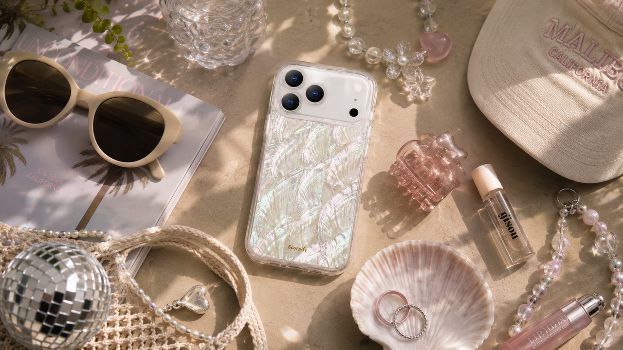 Pearlescent phone case flat lay with Y2K summer accessories and decor