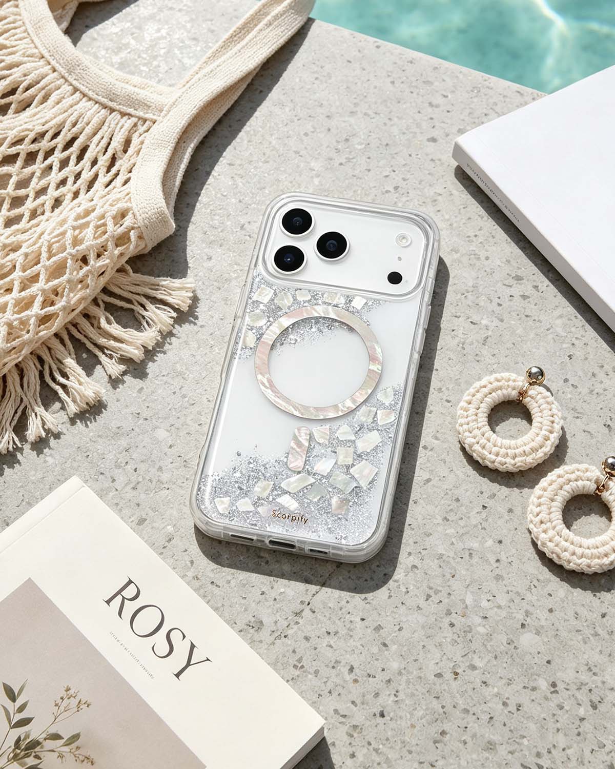 Clear pearlescent phone case flat lay with beach accessories