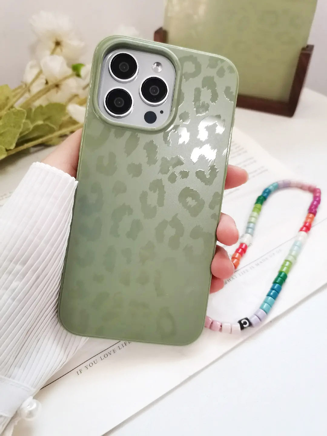 Protective phone case featuring green moss leopard design
