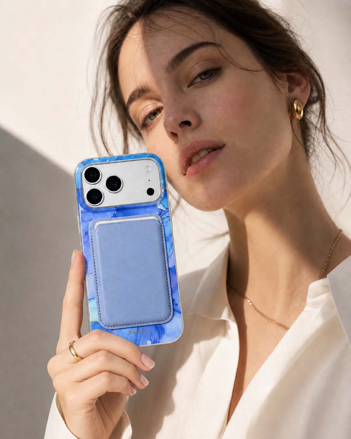Woman holding iPhone with blue lavender phone wallet