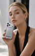 Woman holding iPhone with metallic silver phone wallet