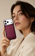 Woman in beige coat holding wine red phone wallet