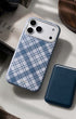 Storm blue phone wallet beside plaid iPhone case