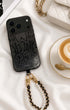 Beaded phone charm with black leather accents