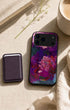 Dark cherry phone wallet with floral iPhone case, flat lay