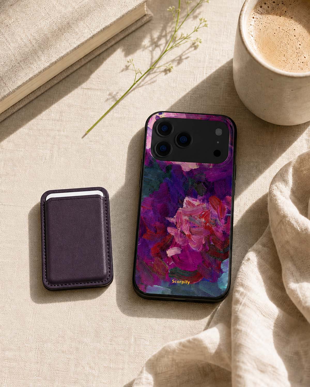 Dark cherry phone wallet with floral iPhone case, flat lay