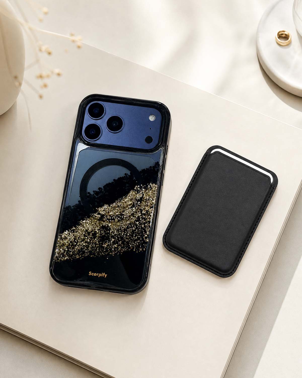 Classic black phone wallet with black glitter iPhone case, flat lay