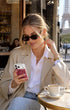Rose Stardust iPhone Case lifestyle shot with accessories