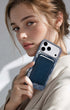 Woman holding iPhone with storm blue phone wallet