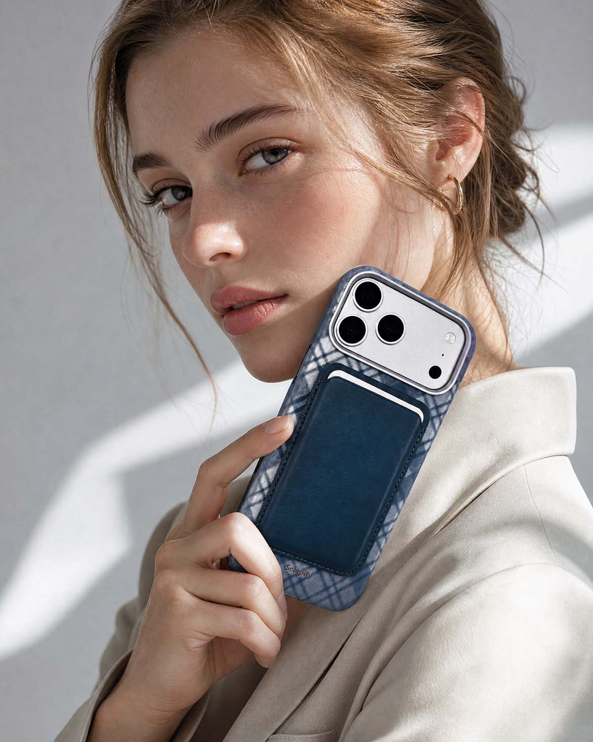Woman holding iPhone with storm blue phone wallet