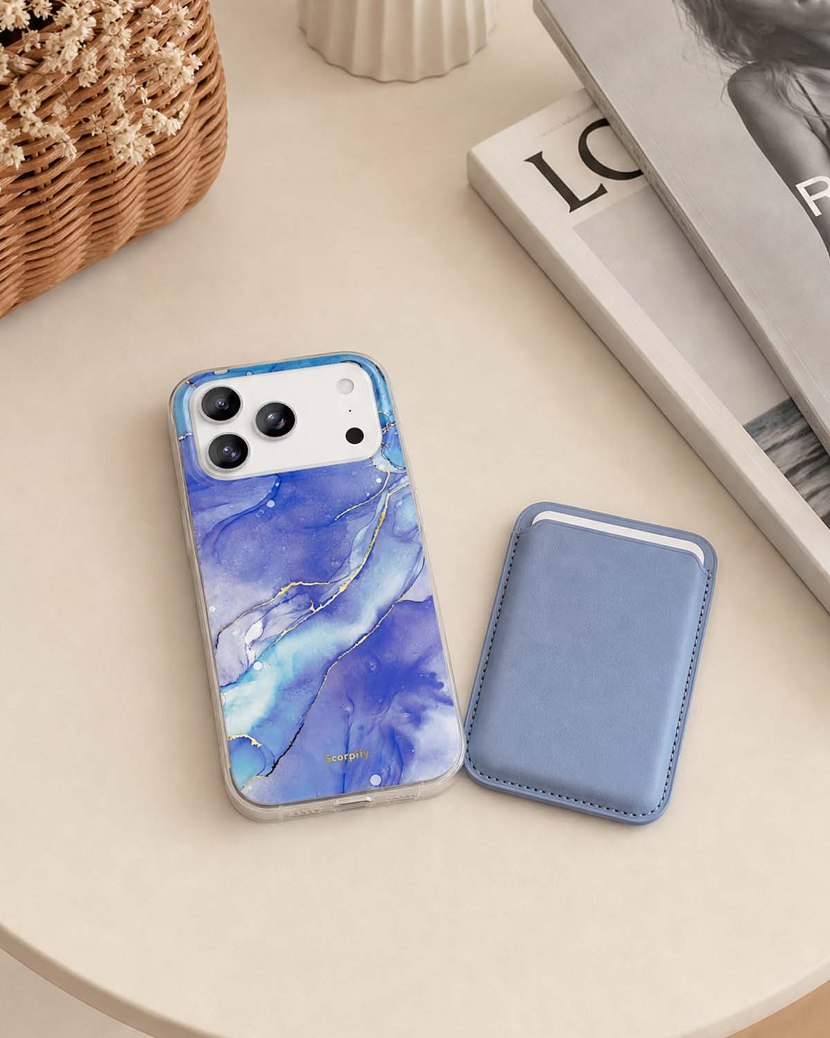 Blue lavender phone wallet beside marble-pattern iPhone case