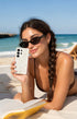Woman on beach holding pearl Samsung phone case
