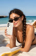 Woman on beach holding pearl Samsung phone case