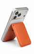 Cosmic orange iPhone MagSafe wallet in stand mode	
