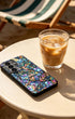 Holographic mosaic phone case on table with iced coffee