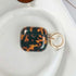Tortoise shell airpod case cover in deep brown tones