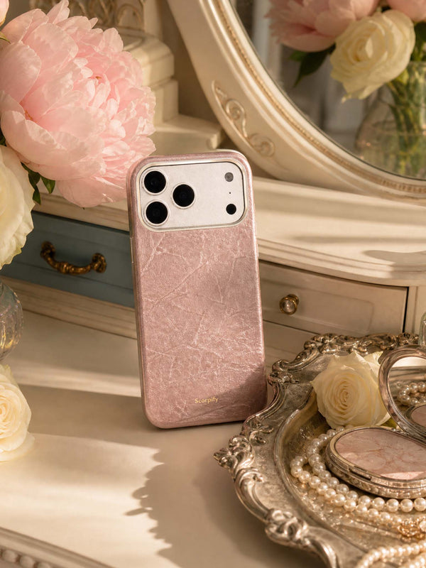 Rose leather phone case styled on a vanity with peonies