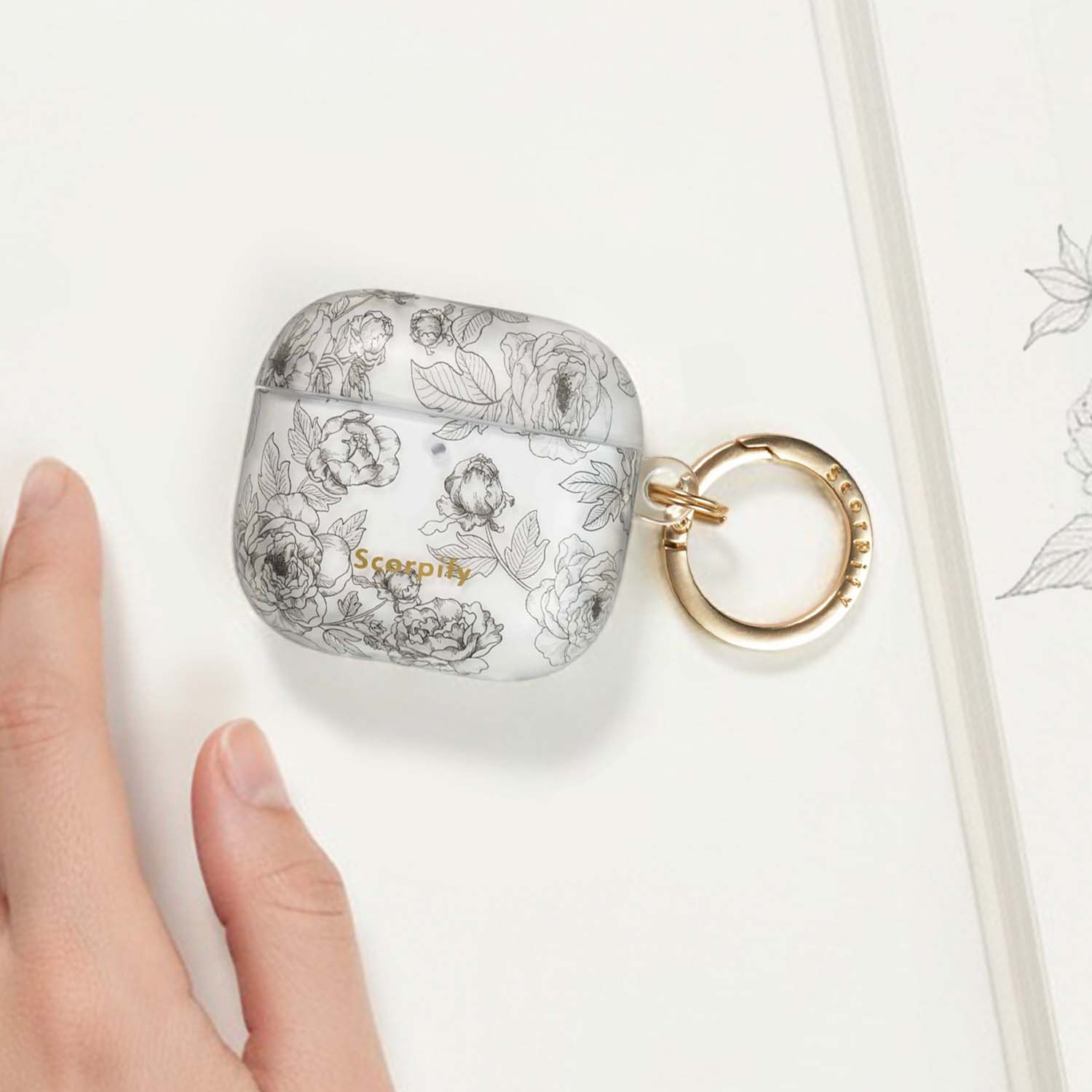 Artistic earbuds case featuring layered floral details