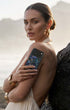 Woman holding gleam mystic abalone iphone case, coastal