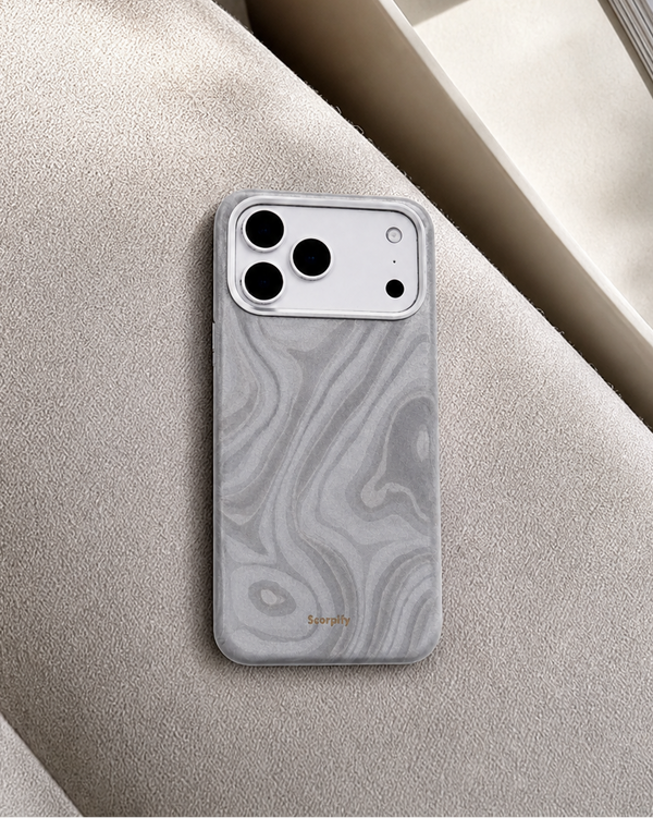 Silver swirl leather iPhone case on suede sofa fabric