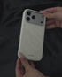 Hand holding ivory swirl leather phone case
