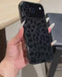 Hand holding black leopard print phone case closeup