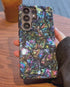 Hand holding iridescent phone case showing shine
